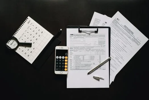 calculator with car tax bill and vehicle registration form