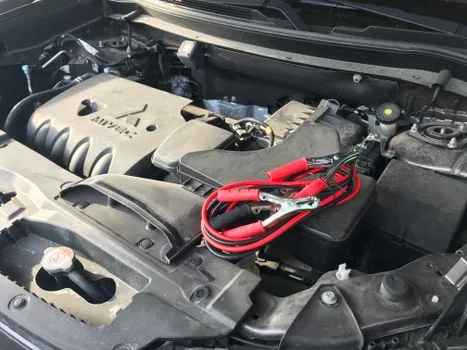 car battery jumper cables engine bay close up