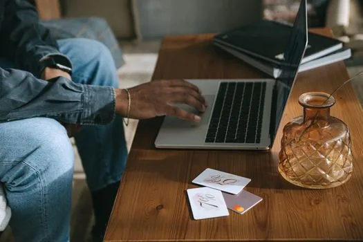 car documents laptop and payment card on desk