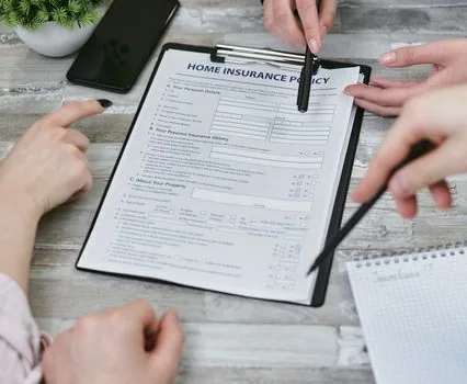 car insurance document and pen on desk