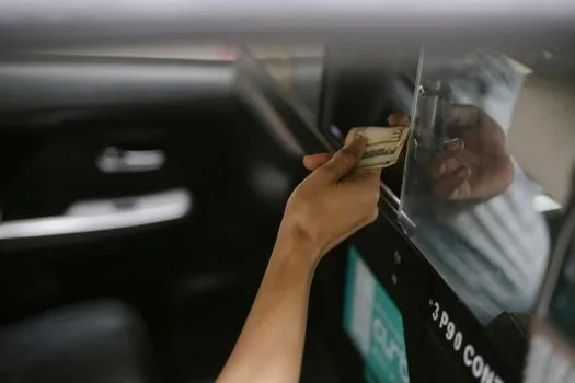 driver checking smartphone payment notification inside parked car