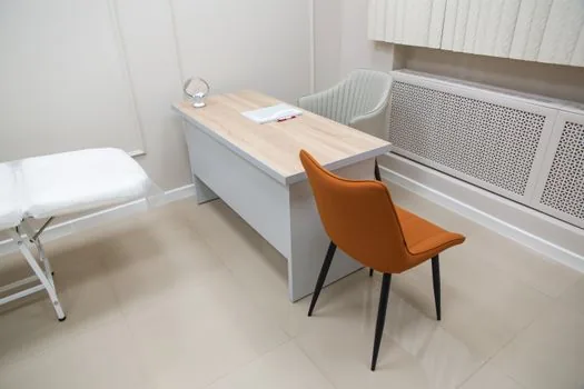local vehicle registration office service desk with blank forms and number ticket in bright clean interior no logos