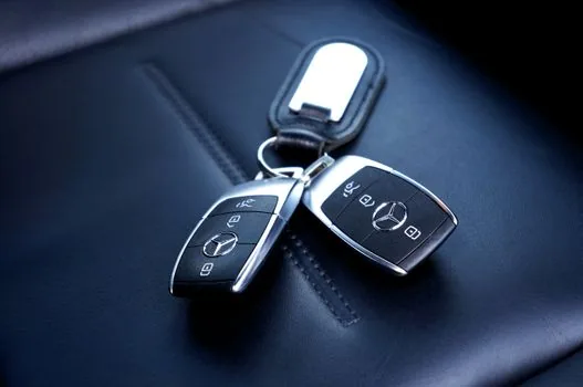 young driver checking car insurance quote with family car key