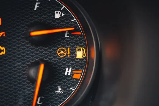close up checking tire pressure gauge hot road