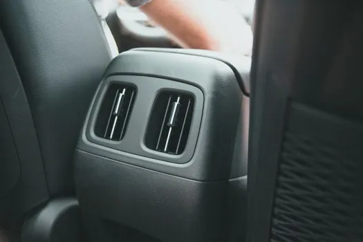 driver ventilating car cabin with air conditioner summer road