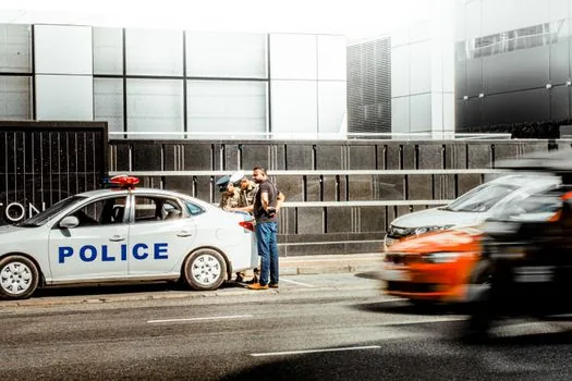 Korean road test scene with compact SUV, court expert monitoring laptop telemetry and RPM graph, police cones and controlled street, realistic documentary photo | 강릉 급발진 의심사고 재현 감정 현장 이미지