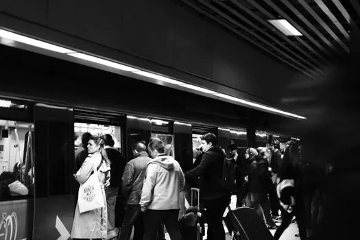crowded train platform with passengers checking departure board and mobile tickets, realistic transportation editorial photo | 매진 시간대 승객들이 승차권과 전광판을 확인하는 플랫폼 장면